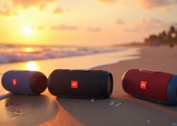 Portable Bluetooth speakers on a beach during sunset, highlighting water resistance
