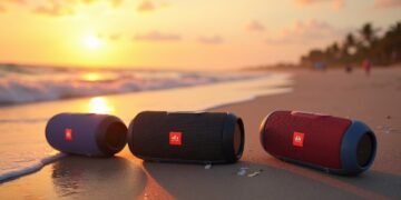 Portable Bluetooth speakers on a beach during sunset, highlighting water resistance