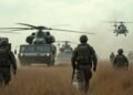German soldiers participating in a military exercise with military vehicles and helicopters