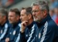 Photograph showing football coaches engaged in discussions during a world cup event