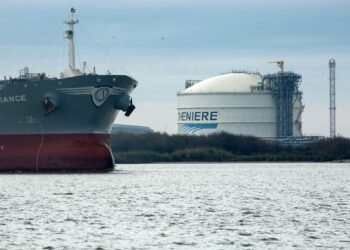 The Amazon Brilliance oil tanker sails past a storage tank at the Cheniere Energy Inc. liquefied natural gas (LNG) terminal in Sabine Pass, Louisiana, U.S., on Thursday, Jan. 14, 2016. Cheniere Energy Inc. said its first cargo of LNG from its new Louisiana export terminal will be delayed by as much as two months because of faulty wiring. Photographer: F. Carter Smith/Bloomberg via Getty Images