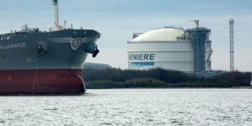 The Amazon Brilliance oil tanker sails past a storage tank at the Cheniere Energy Inc. liquefied natural gas (LNG) terminal in Sabine Pass, Louisiana, U.S., on Thursday, Jan. 14, 2016. Cheniere Energy Inc. said its first cargo of LNG from its new Louisiana export terminal will be delayed by as much as two months because of faulty wiring. Photographer: F. Carter Smith/Bloomberg via Getty Images
