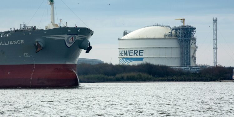The Amazon Brilliance oil tanker sails past a storage tank at the Cheniere Energy Inc. liquefied natural gas (LNG) terminal in Sabine Pass, Louisiana, U.S., on Thursday, Jan. 14, 2016. Cheniere Energy Inc. said its first cargo of LNG from its new Louisiana export terminal will be delayed by as much as two months because of faulty wiring. Photographer: F. Carter Smith/Bloomberg via Getty Images